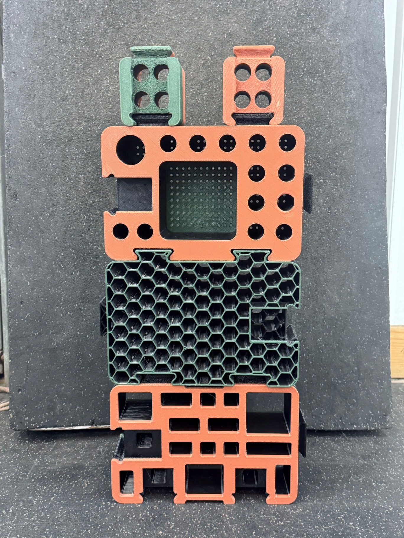 Stack of orange and green D-Block face designs, including honeycomb and grid patterns