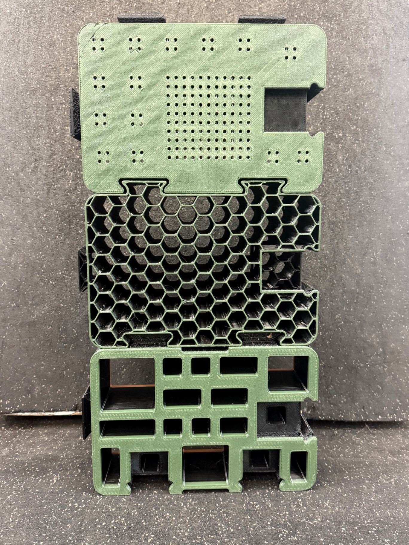 Stack of green D-Block face designs: fine-hole panel, honeycomb and grid patterns